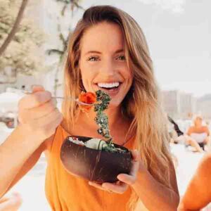vegan bowl girl eating coconut bowl